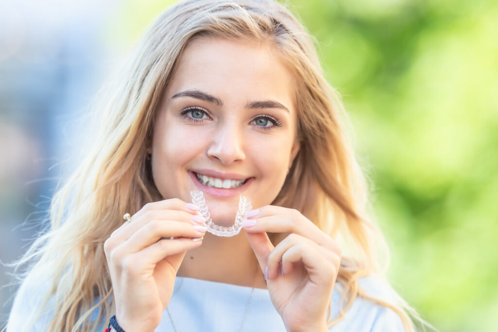 teenager holding invisalign